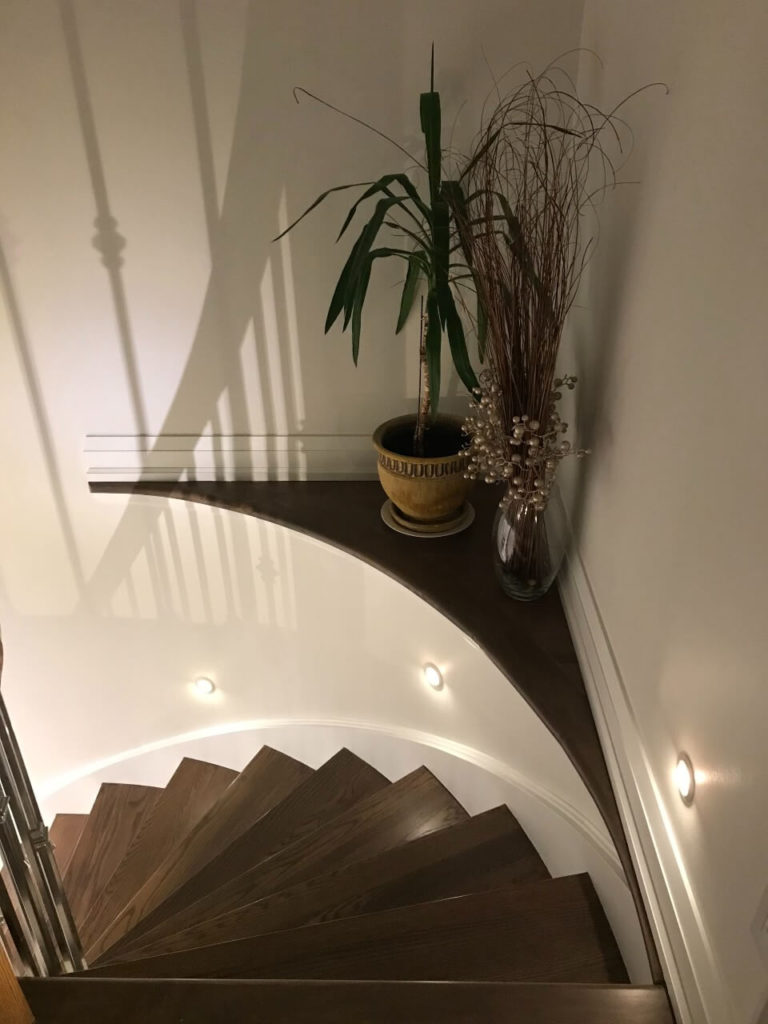 Round recessed wall LED stair lights along a staircase