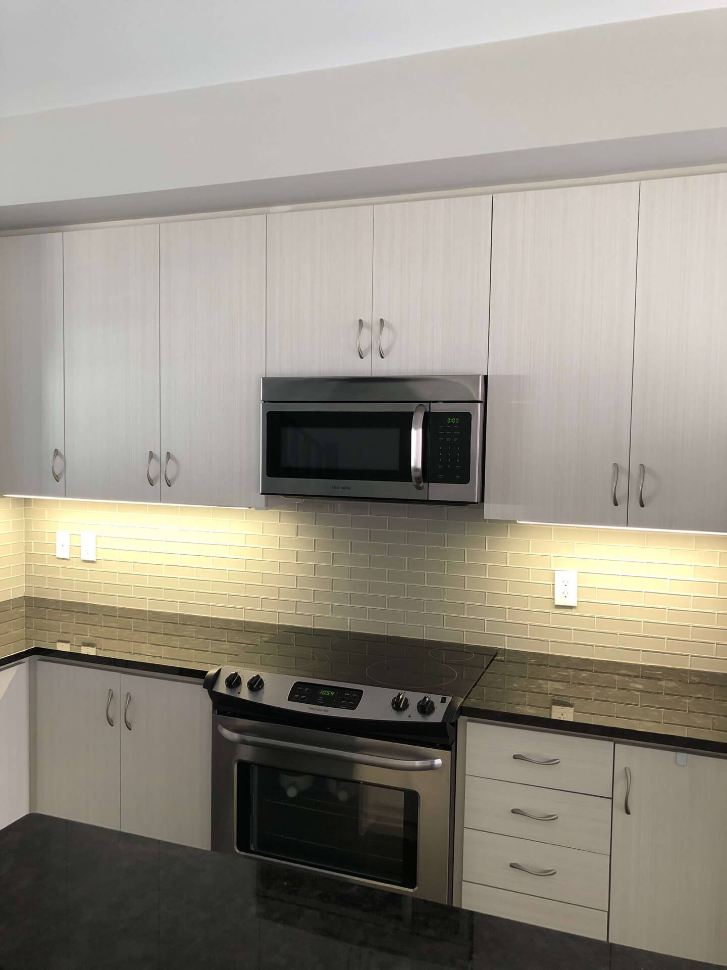 Under-cabinet lighting around a kitchen gas range area