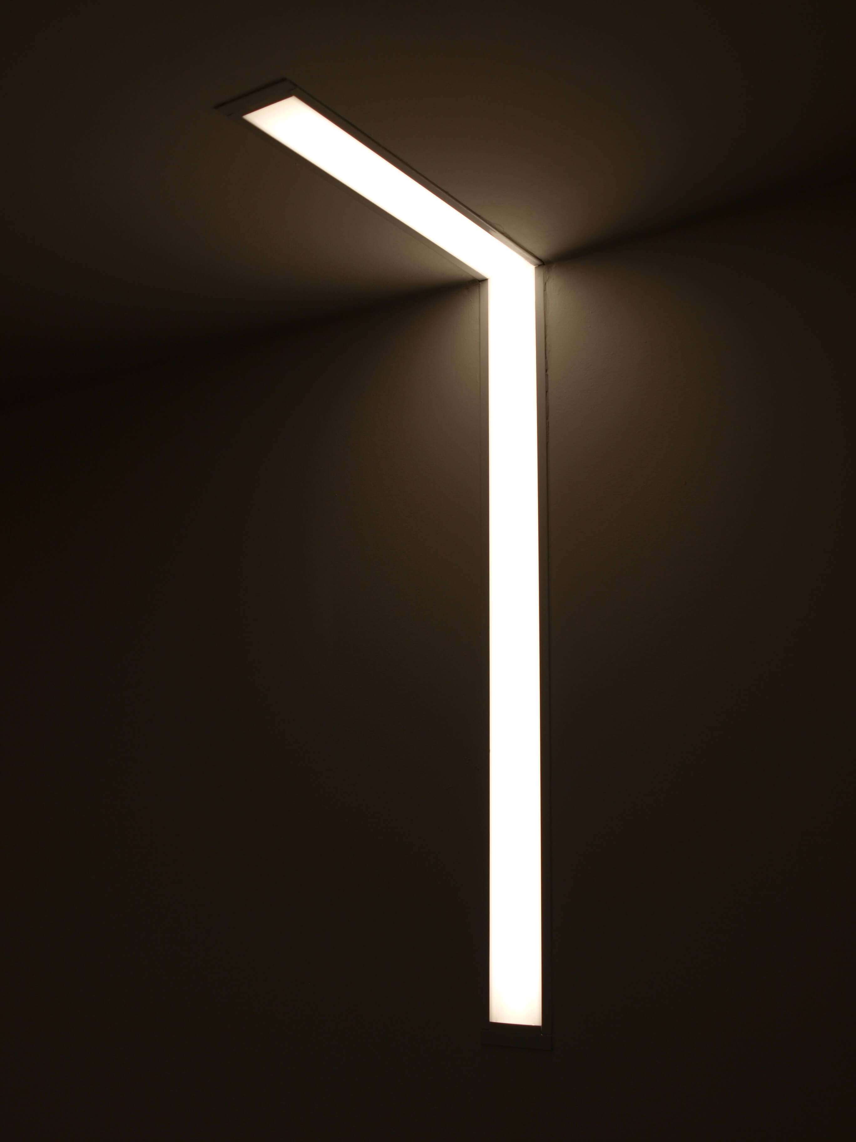 Corner detail of custom linear LED lighting in a basement office
