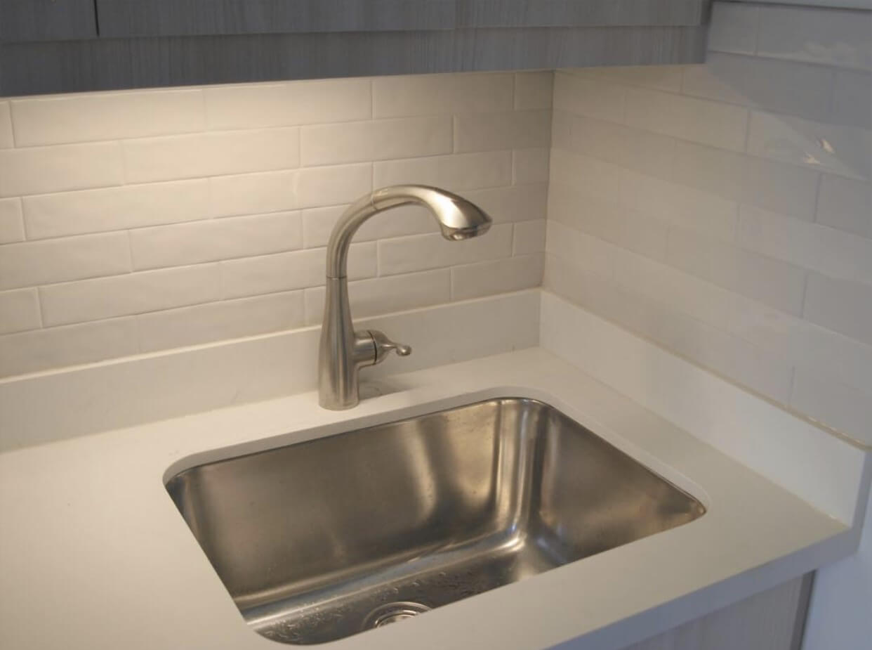 Under-cabinet task lighting illuminating a kitchen work surface