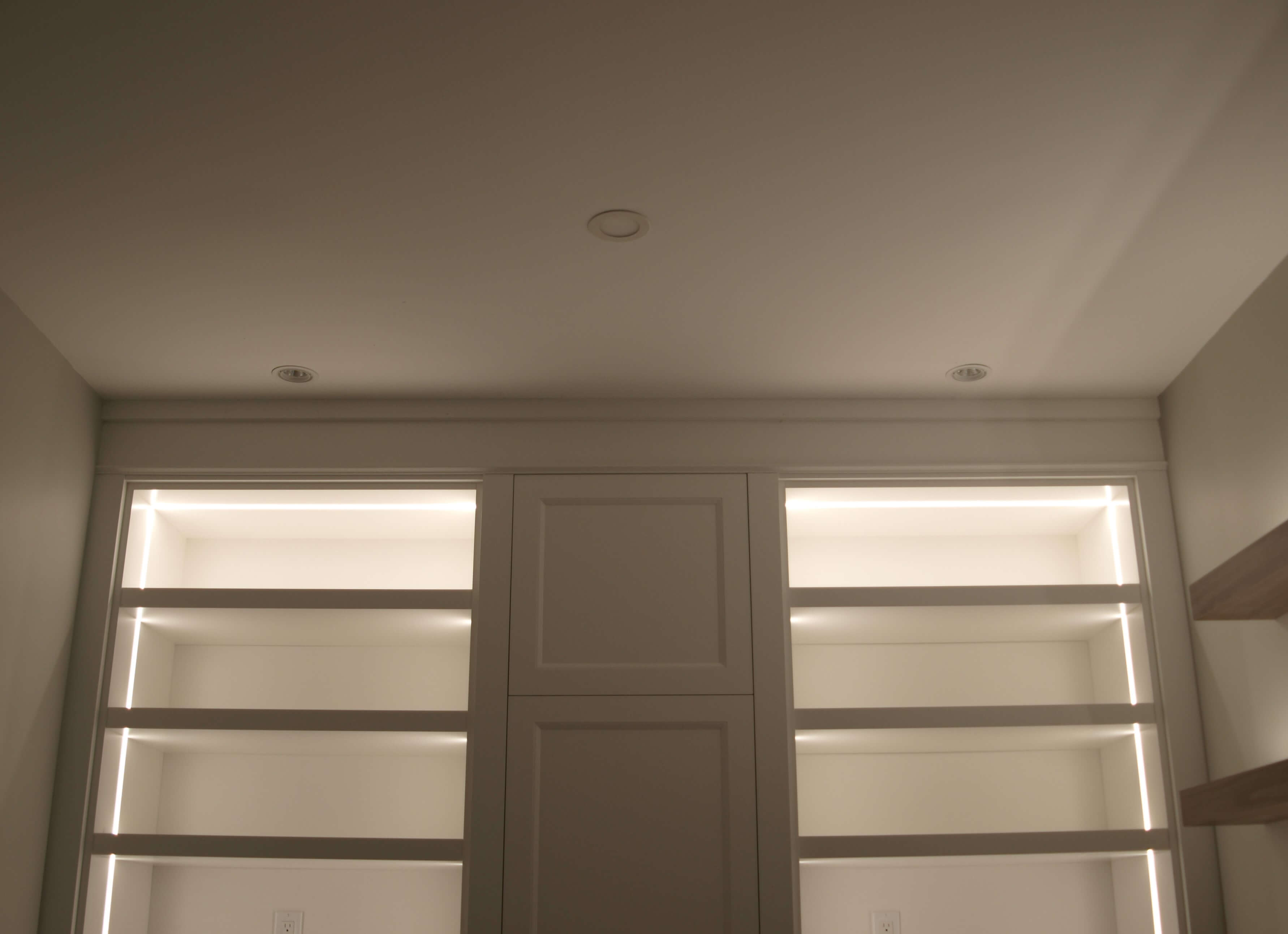 Home office millwork with integrated linear shelf lighting