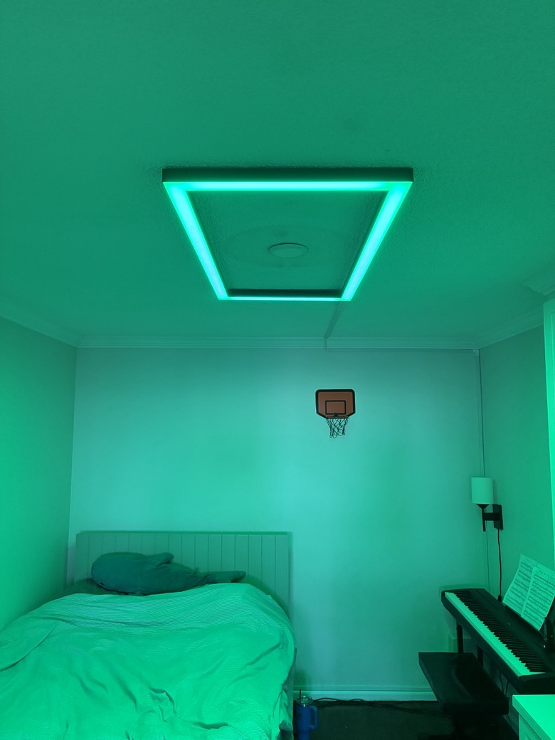 Bedroom lit in green by the custom RGB LED ceiling fixture